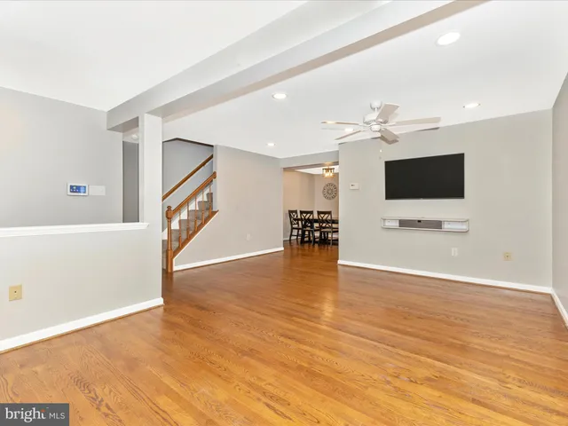 a kitchen with stainless steel appliances granite countertop white cabinets a sink a stove a refrigerator and white cabinets