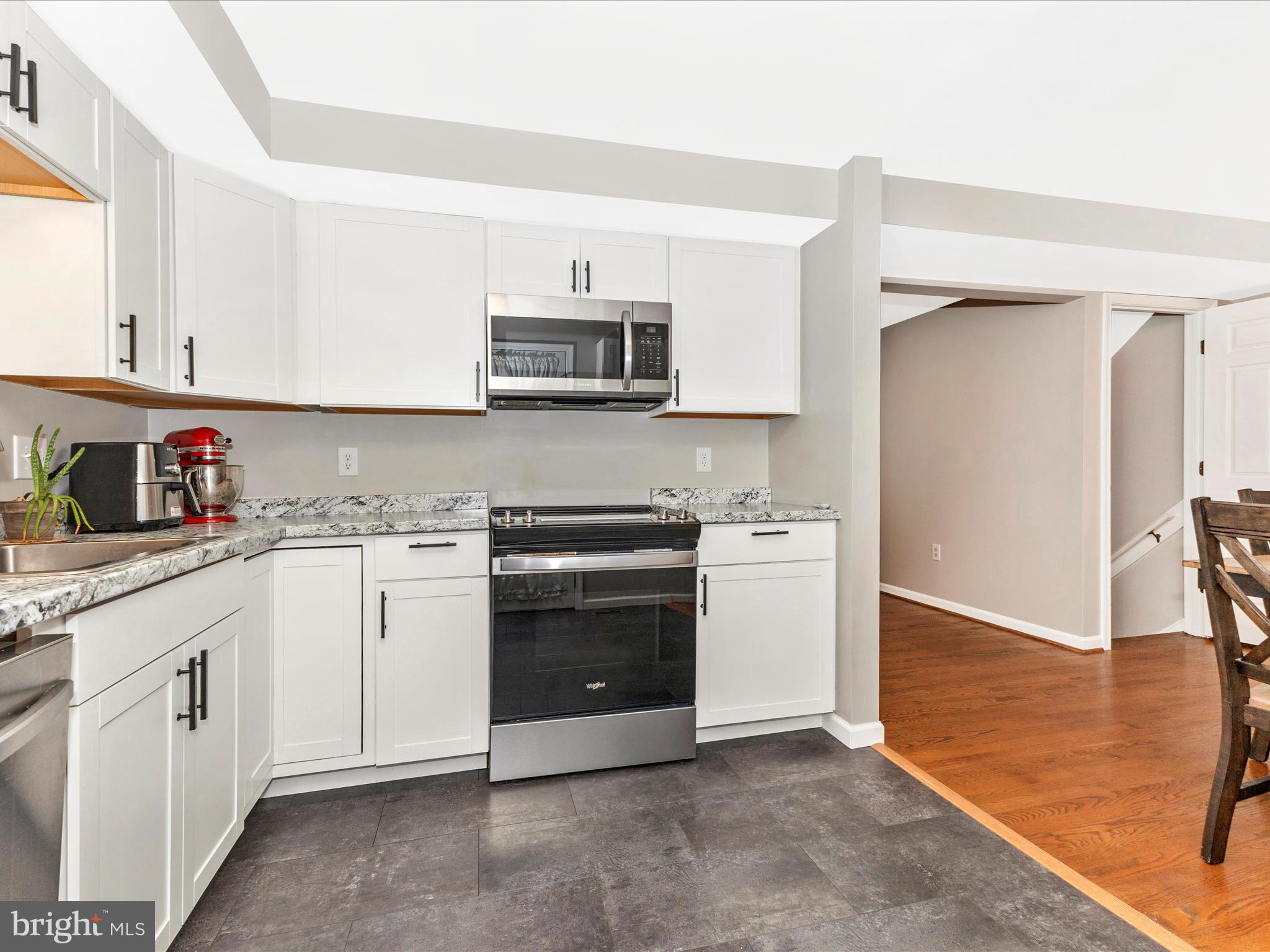 8204 Red Wing Court Frederick, MD 21701 - Photo 9 of 72 a kitchen with stainless steel appliances granite countertop white cabinets a sink a stove a refrigerator and white cabinets