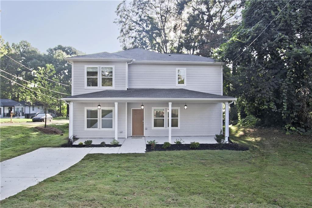 a front view of a house with a garden