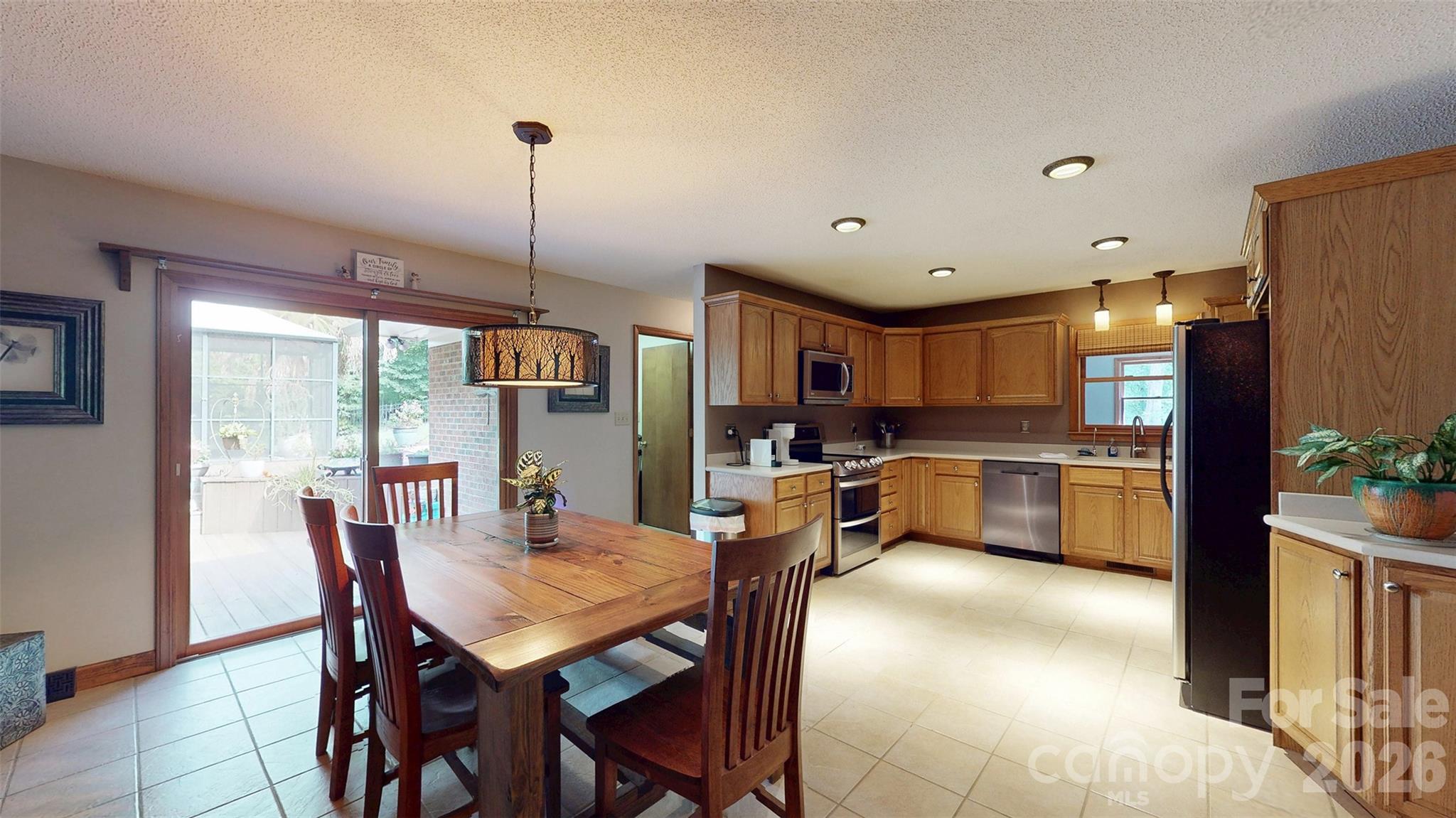 8720 Unionville-Brief Road Monroe, NC 28110 - Photo 25 of 35 a dining room kitchen with a large window and stainless steel appliances