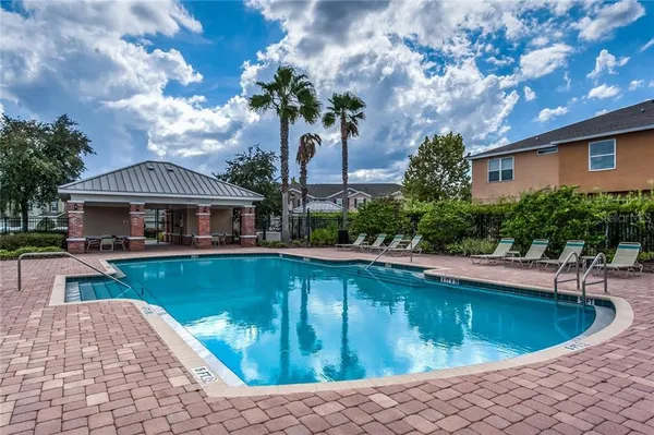 a view of a house with a swimming pool and sitting area