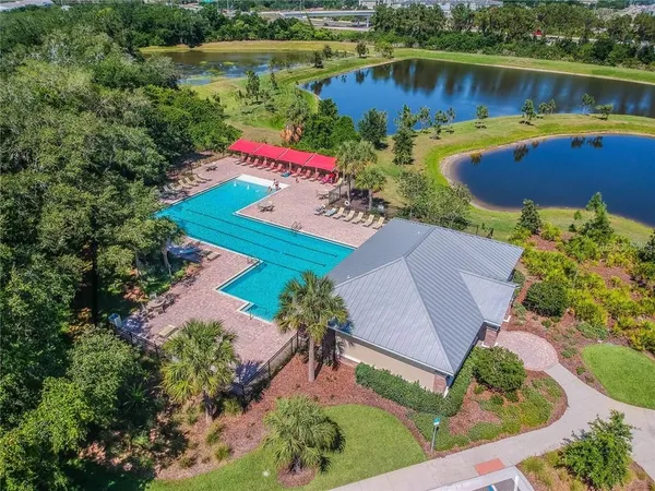 an aerial view of a house with a yard and lake view