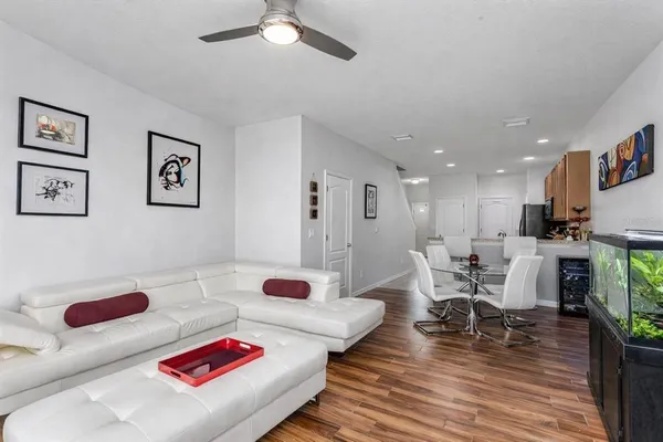a living room with furniture and a wooden floor