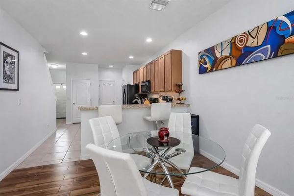 a living room with furniture and kitchen view