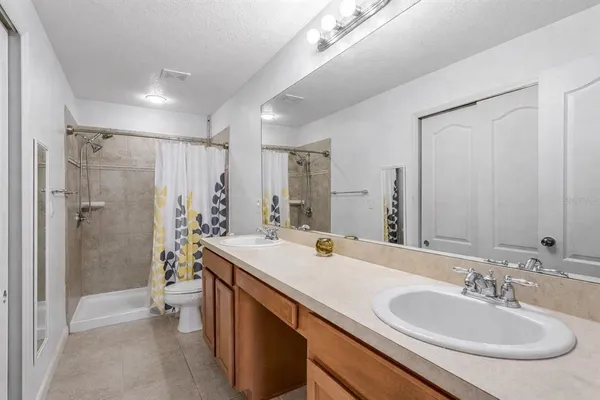 a bathroom with a sink double vanity shower and a mirror