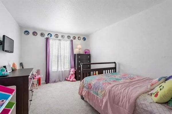 a bedroom with a bed dresser and a window