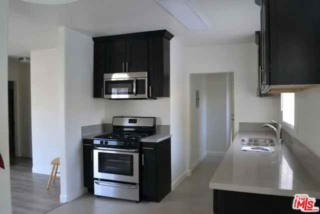a kitchen with granite countertop a stove and a sink