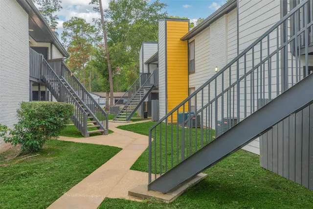 a view of house with backyard and deck