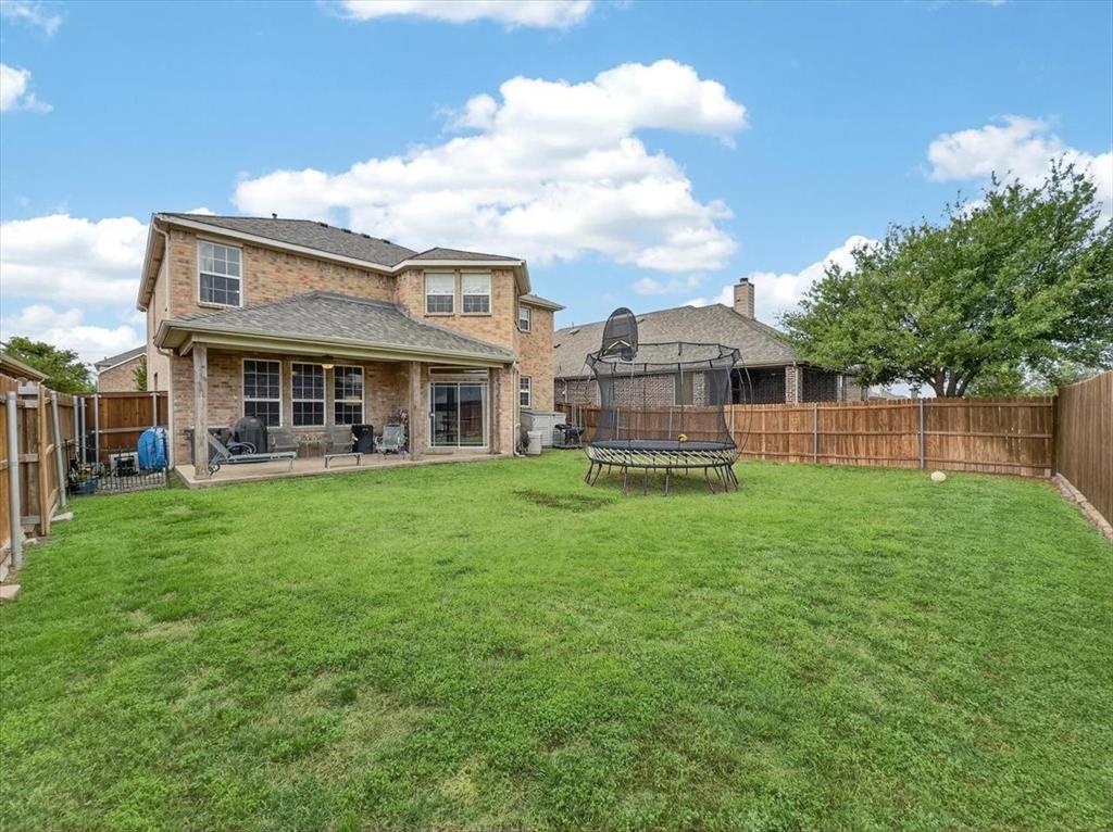 2679 Lake Ridge Drive Little Elm, TX 75068 - Photo 2 of 40 a view of a house with a backyard