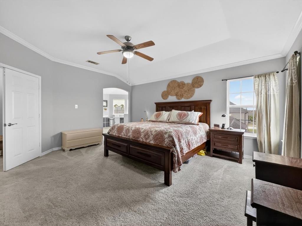 2679 Lake Ridge Drive Little Elm, TX 75068 - Photo 19 of 40 a bedroom with a bed and ceiling fan