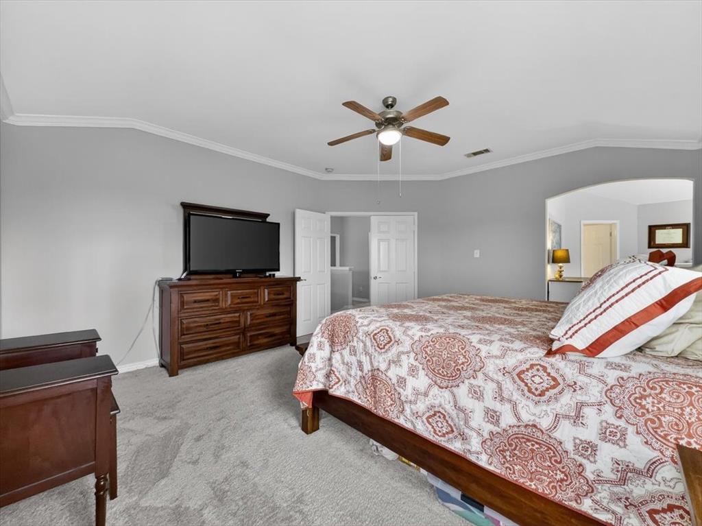 2679 Lake Ridge Drive Little Elm, TX 75068 - Photo 21 of 40 a bedroom with a bed and a flat screen tv