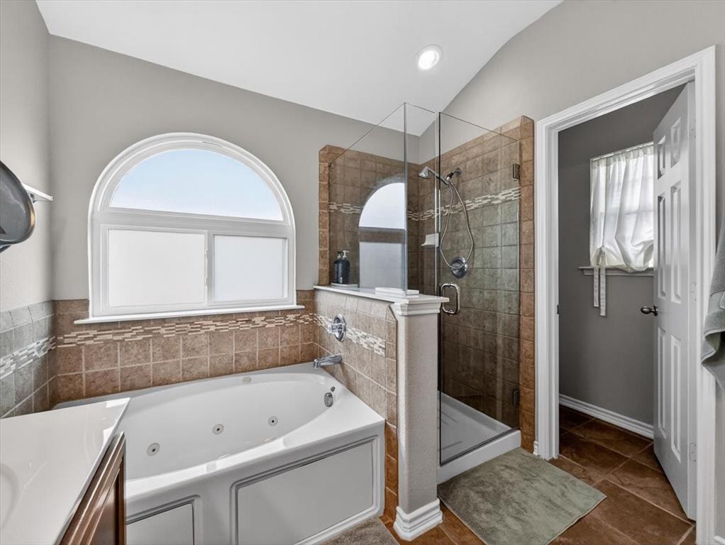 2679 Lake Ridge Drive Little Elm, TX 75068 - Photo 23 of 40 a bathroom with a tub a sink and a large mirror