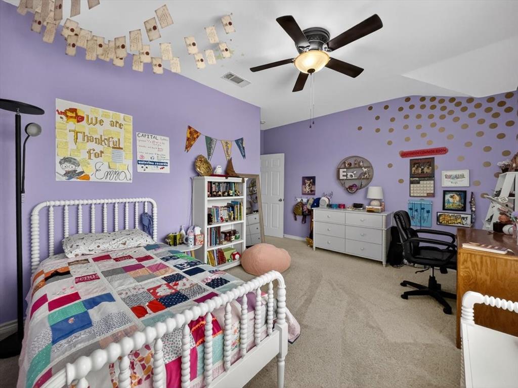 2679 Lake Ridge Drive Little Elm, TX 75068 - Photo 28 of 40 a bedroom that has a bed and a table in it