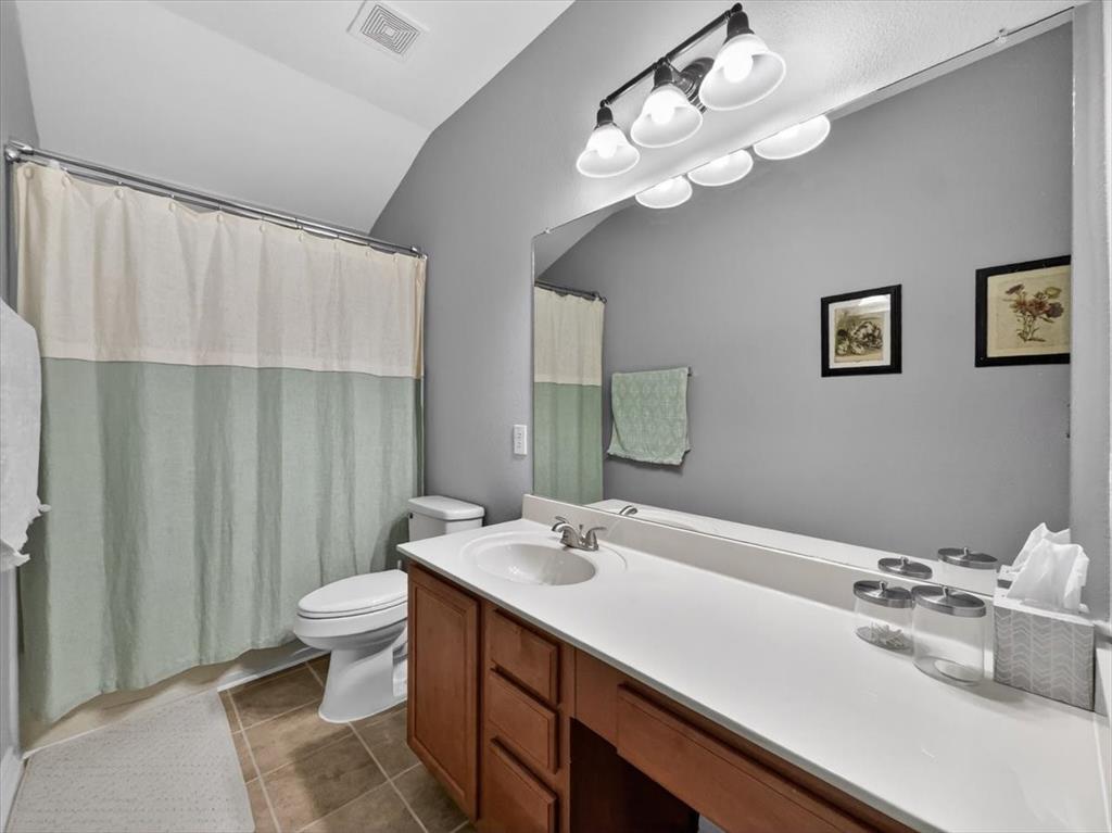 2679 Lake Ridge Drive Little Elm, TX 75068 - Photo 30 of 40 a bathroom with a double vanity sink mirror and toilet