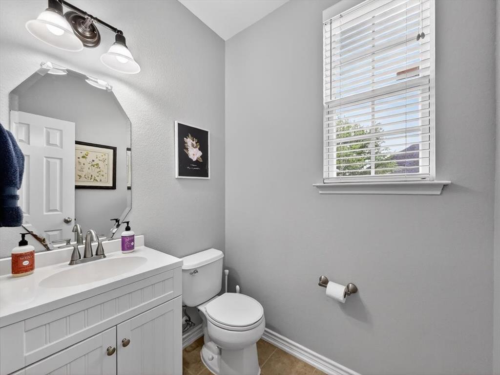 2679 Lake Ridge Drive Little Elm, TX 75068 - Photo 33 of 40 a bathroom with a sink vanity granite and toilet