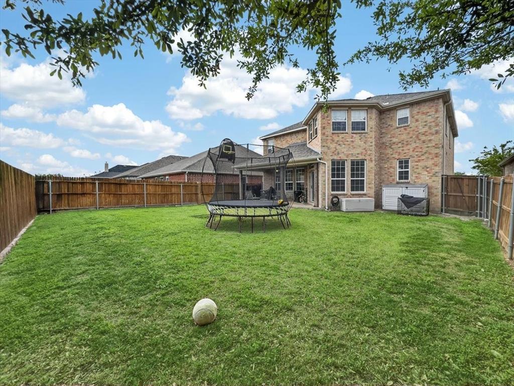 2679 Lake Ridge Drive Little Elm, TX 75068 - Photo 36 of 40 a view of a house with backyard and porch