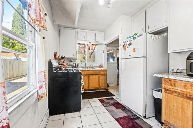 a refrigerator freezer sitting inside of a kitchen