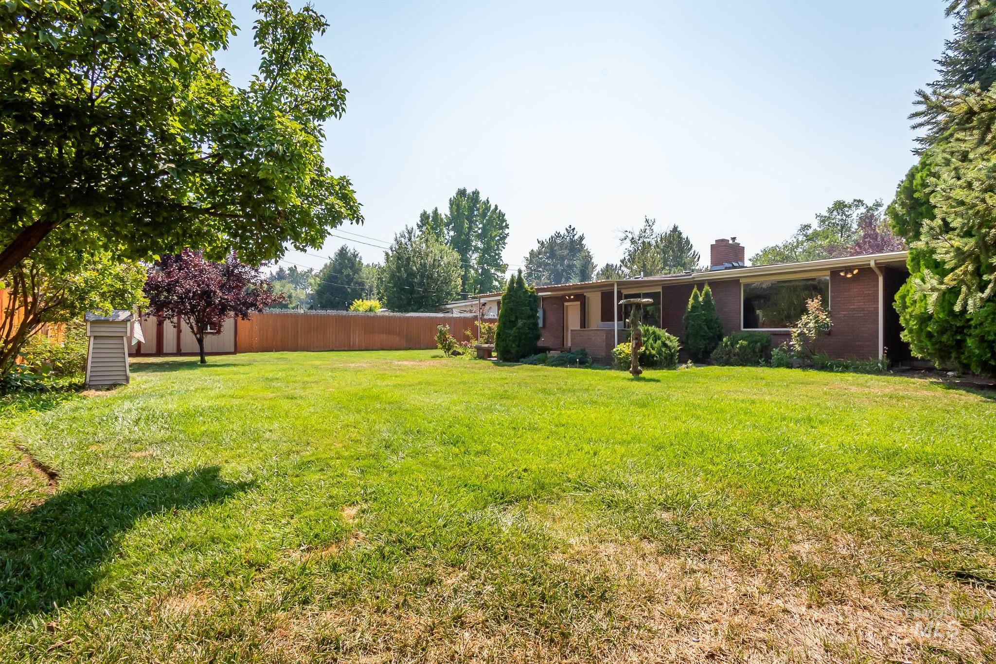 3706 West Clement Road Boise, ID 83704 - Photo 31 of 36 Expansive lawn with mature trees and a privacy fence