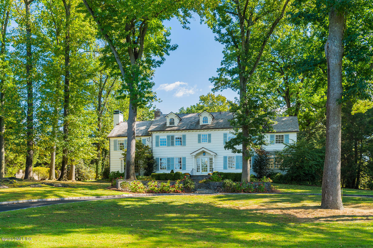 10 Indian Chase Drive Greenwich, CT 06830 - Photo 23 of 27 a view of a house with a big yard and large trees