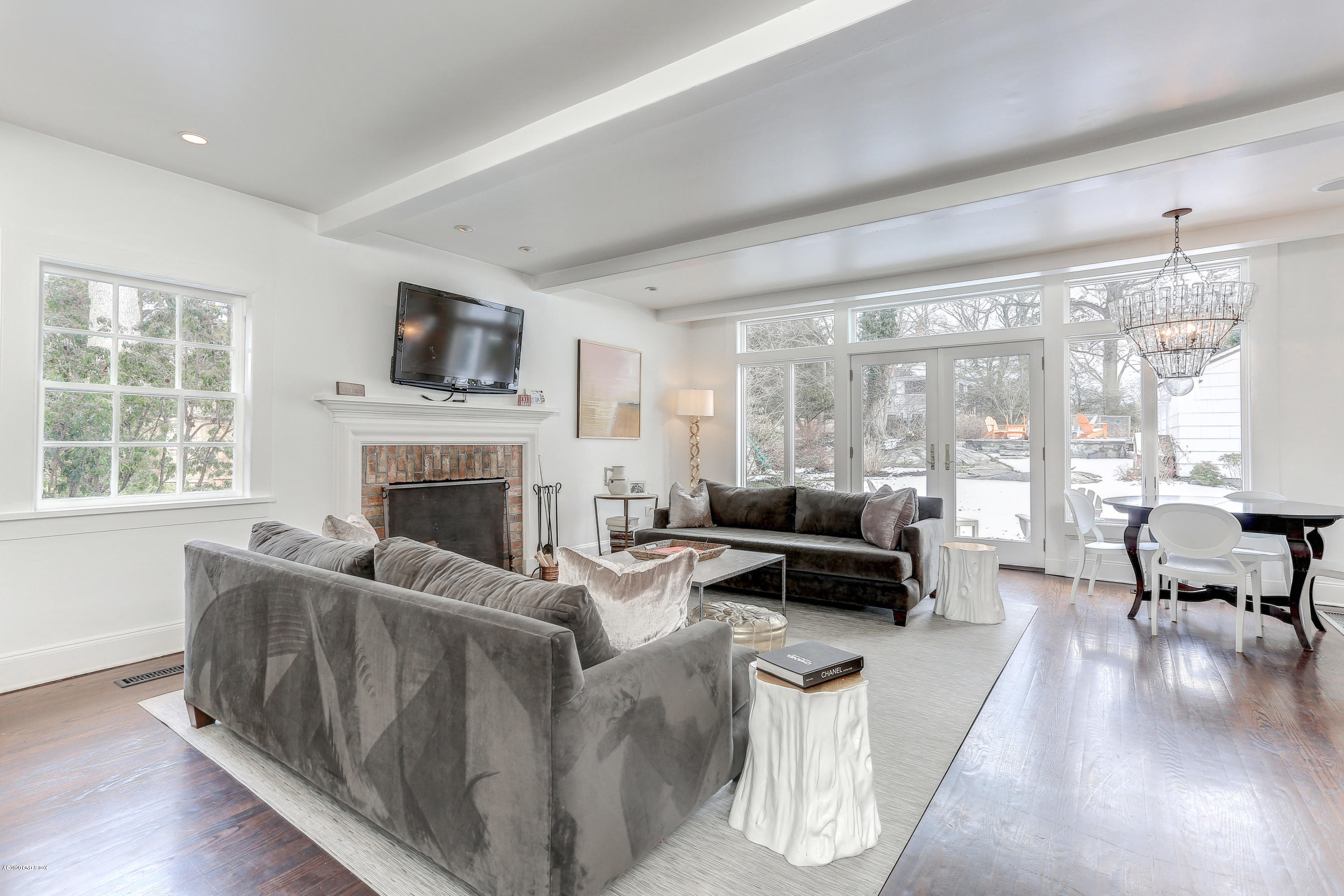 10 Indian Chase Drive Greenwich, CT 06830 - Photo 4 of 27 a living room with furniture flat screen tv and a fireplace