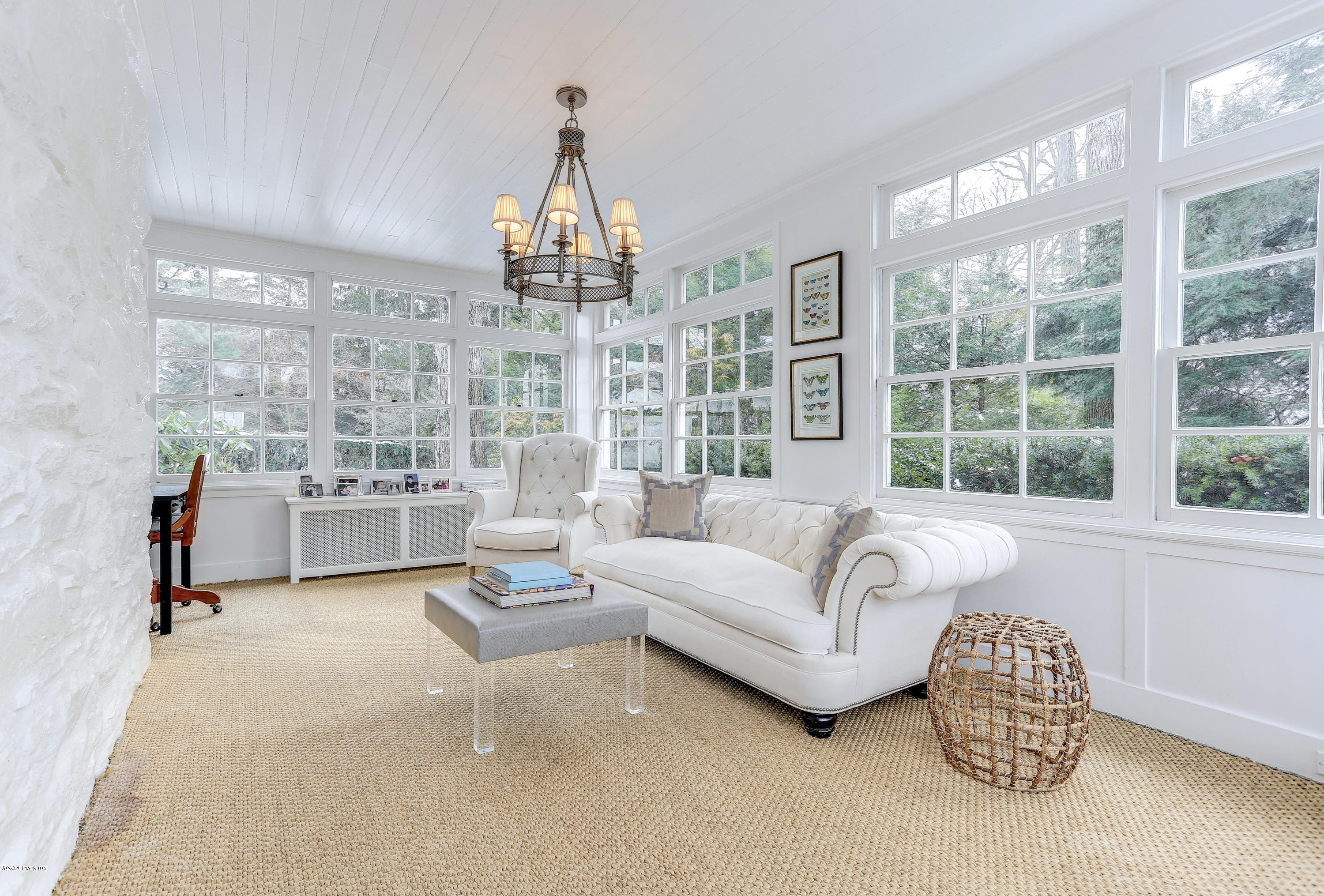 10 Indian Chase Drive Greenwich, CT 06830 - Photo 7 of 27 a living room with furniture and a chandelier