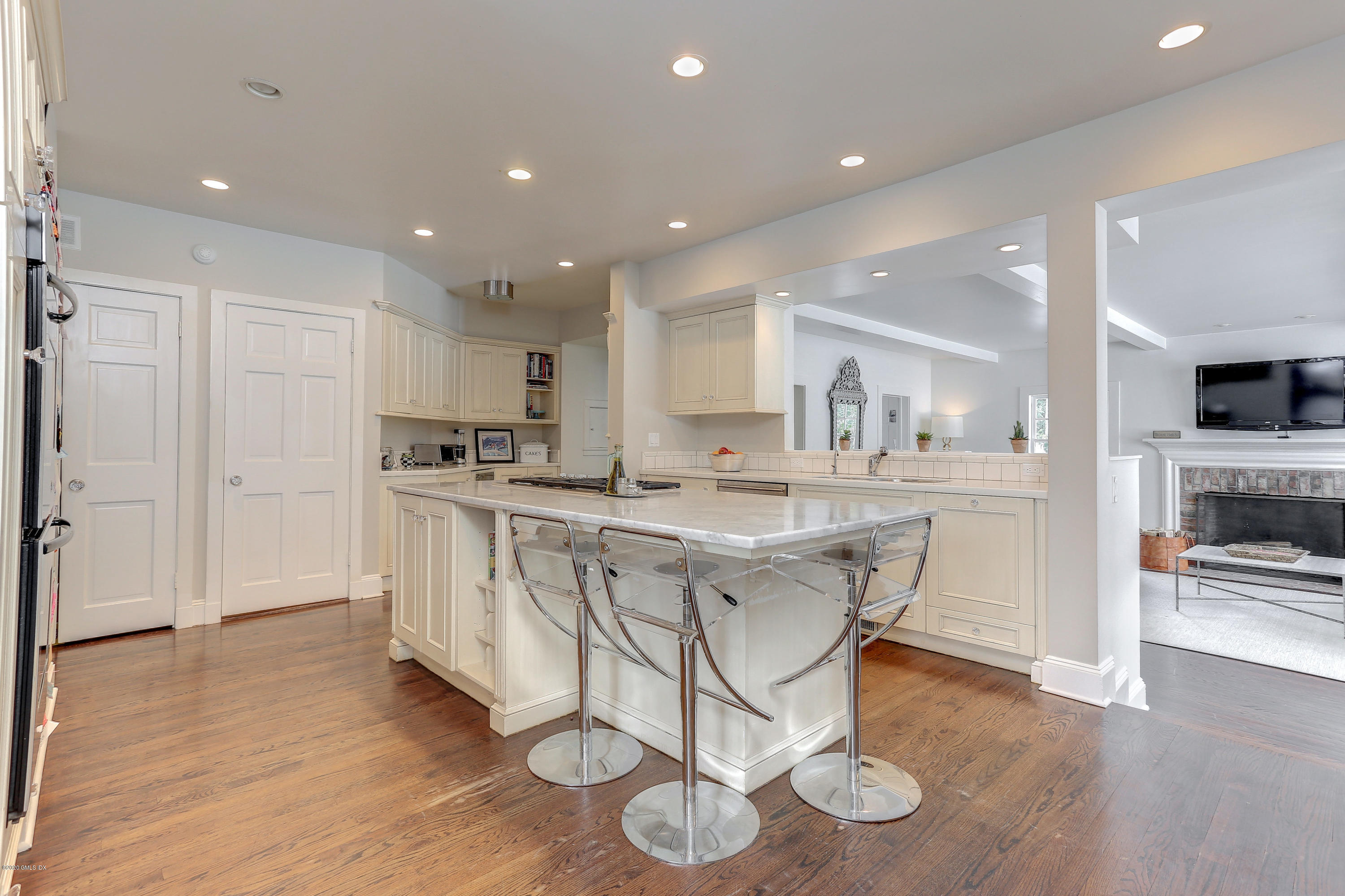 10 Indian Chase Drive Greenwich, CT 06830 - Photo 8 of 27 a kitchen with stainless steel appliances granite countertop a white cabinets and wooden floor