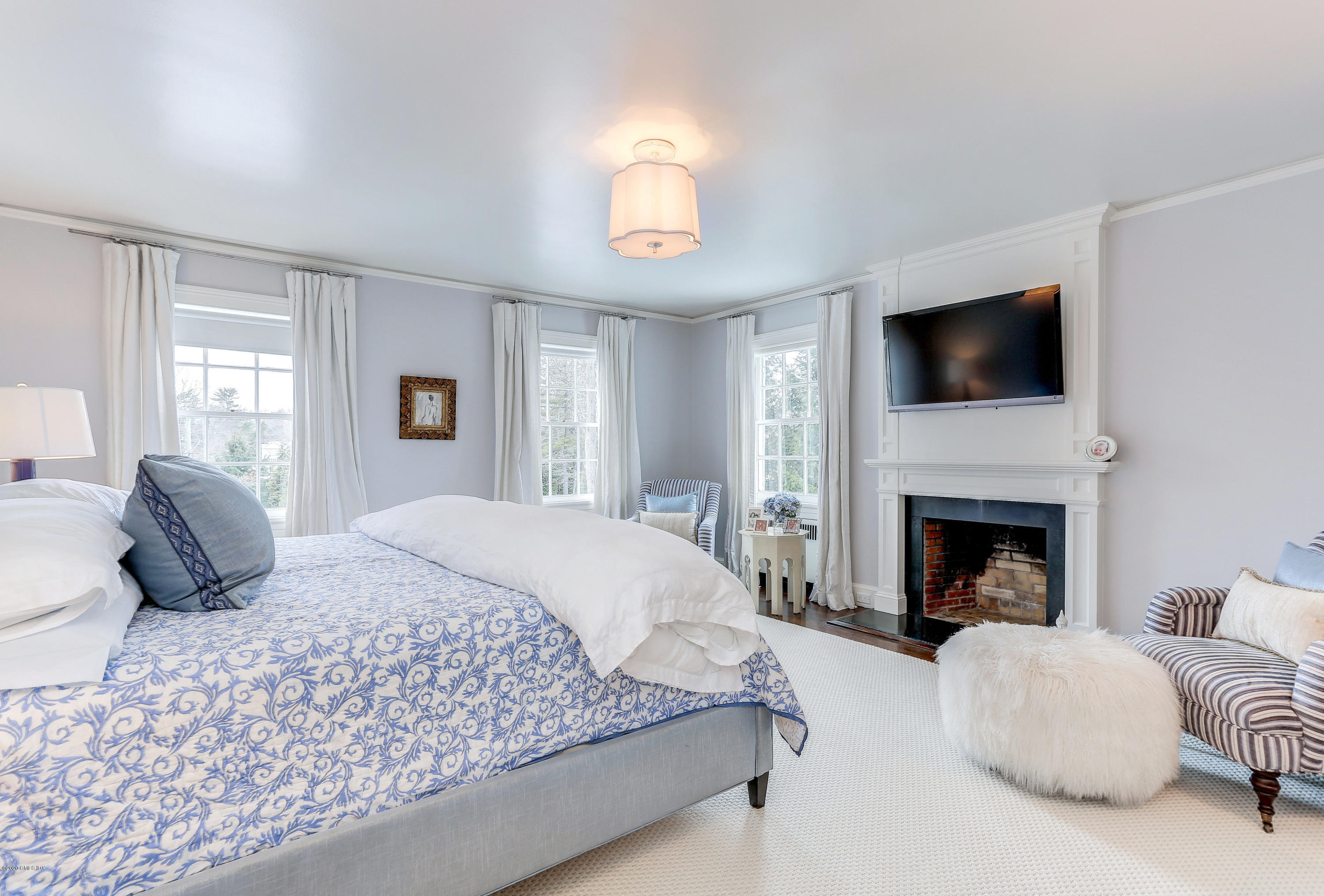 10 Indian Chase Drive Greenwich, CT 06830 - Photo 10 of 27 a bedroom with a bed and a fireplace