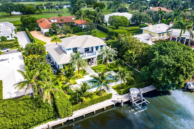 an aerial view of a house with swimming pool garden and outdoor seating