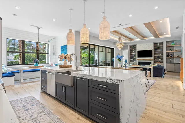 a kitchen with stainless steel appliances kitchen island granite countertop a sink and wooden cabinets