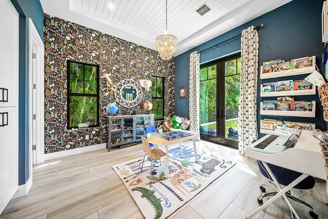 a living room with furniture a flat screen tv and a floor to ceiling window