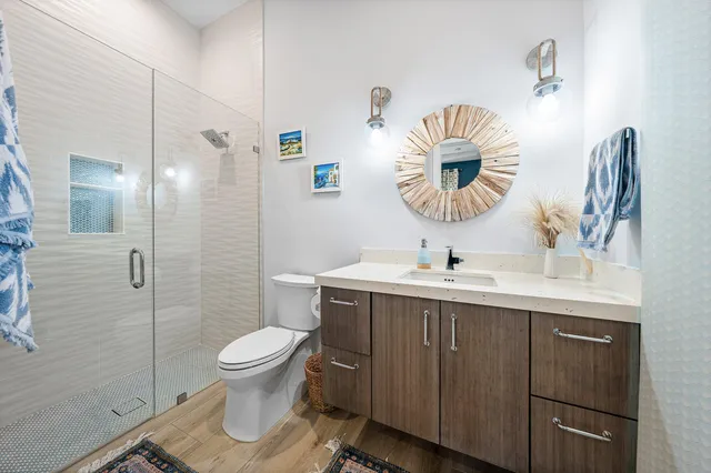 a bathroom with a sink toilet and a mirror