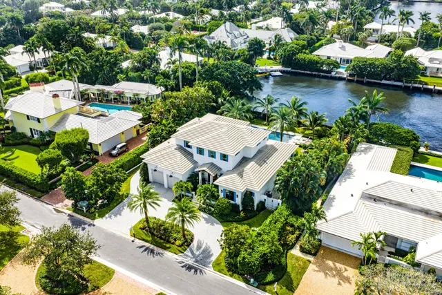 an aerial view of a house with a garden and lake view
