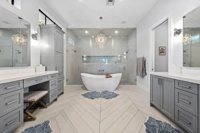 a view of a bathroom with a sink and a large mirror
