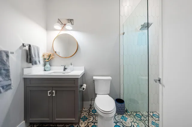 a bathroom with a toilet sink and mirror