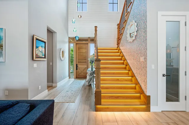 a view of entryway and hall with wooden floor