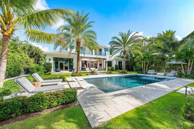a view of a house with swimming pool and a big yard