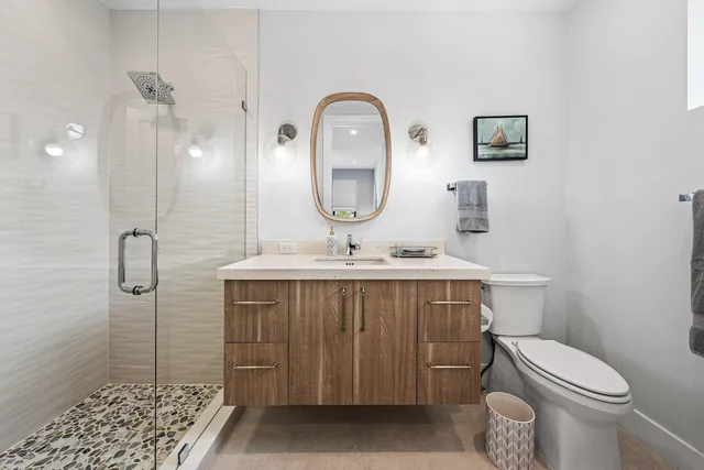 a bathroom with a toilet a sink and mirror