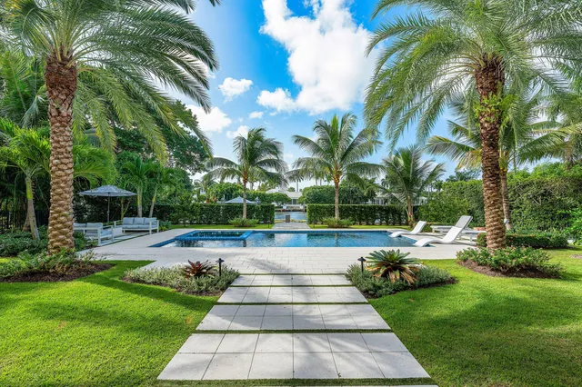 a view of yard with swimming pool and green space