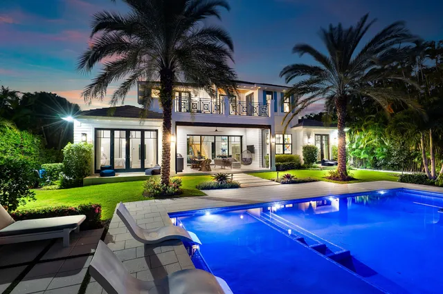 a view of swimming pool with chairs and table
