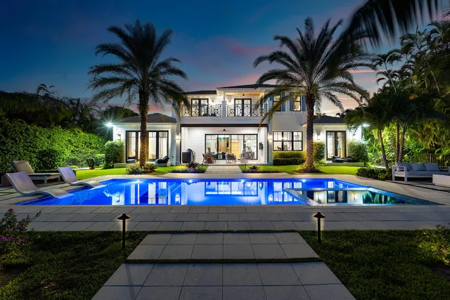 a view of a lake with boats and palm trees