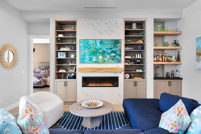 a living room with furniture and a book shelf