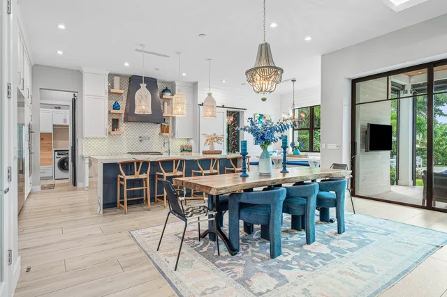 a view of a dining room and livingroom with furniture wooden floor and a clock
