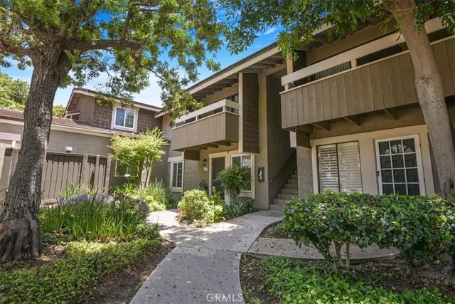 a front view of a house with garden and plants