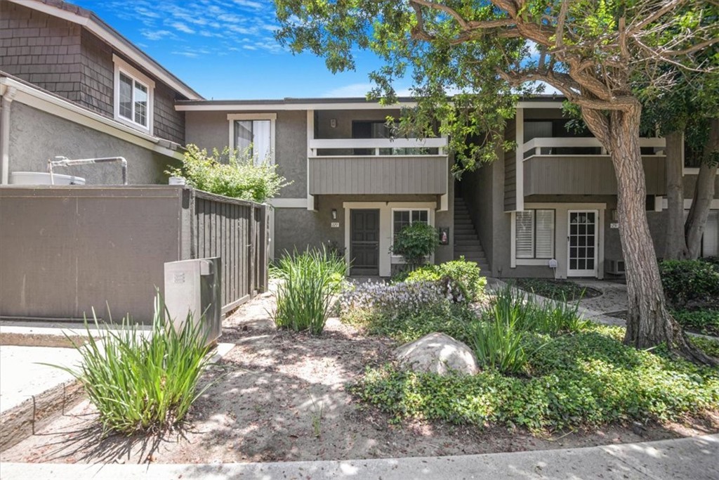 229 Springview Irvine, CA 92620 - Photo 28 of 30 a front view of a house with garden and plants