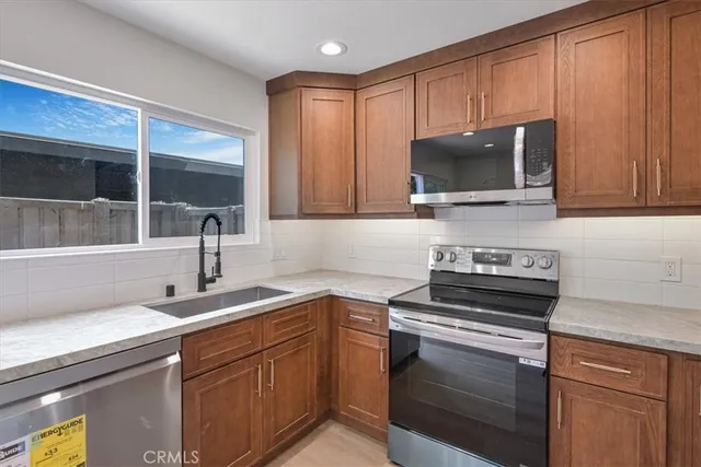 a kitchen with a sink stove and microwave