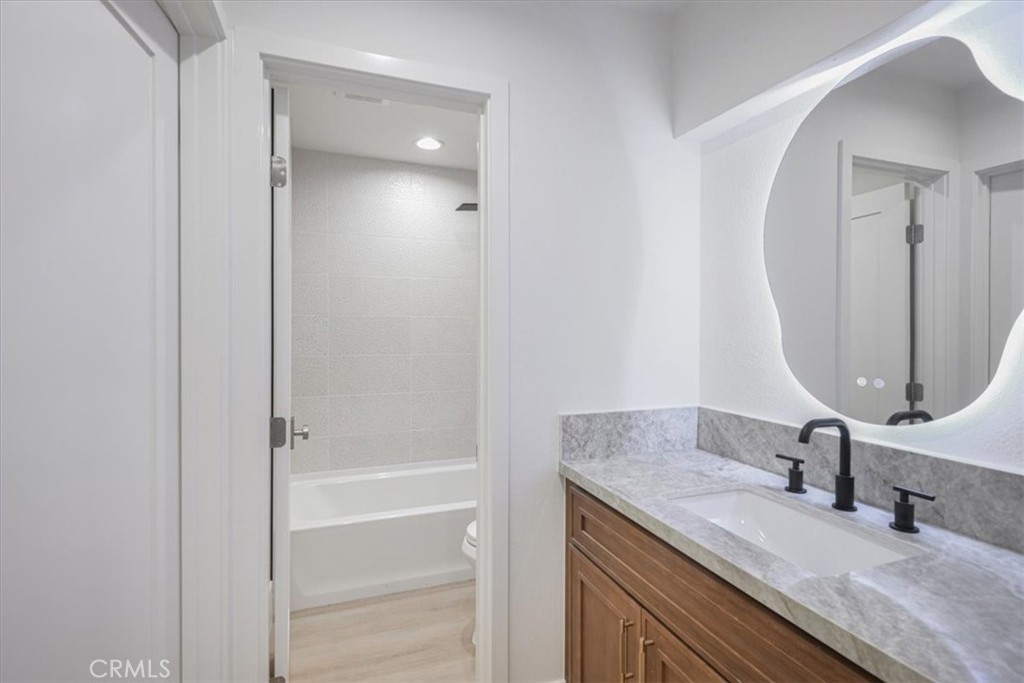 229 Springview Irvine, CA 92620 - Photo 9 of 30 a bathroom with a granite countertop sink and a mirror