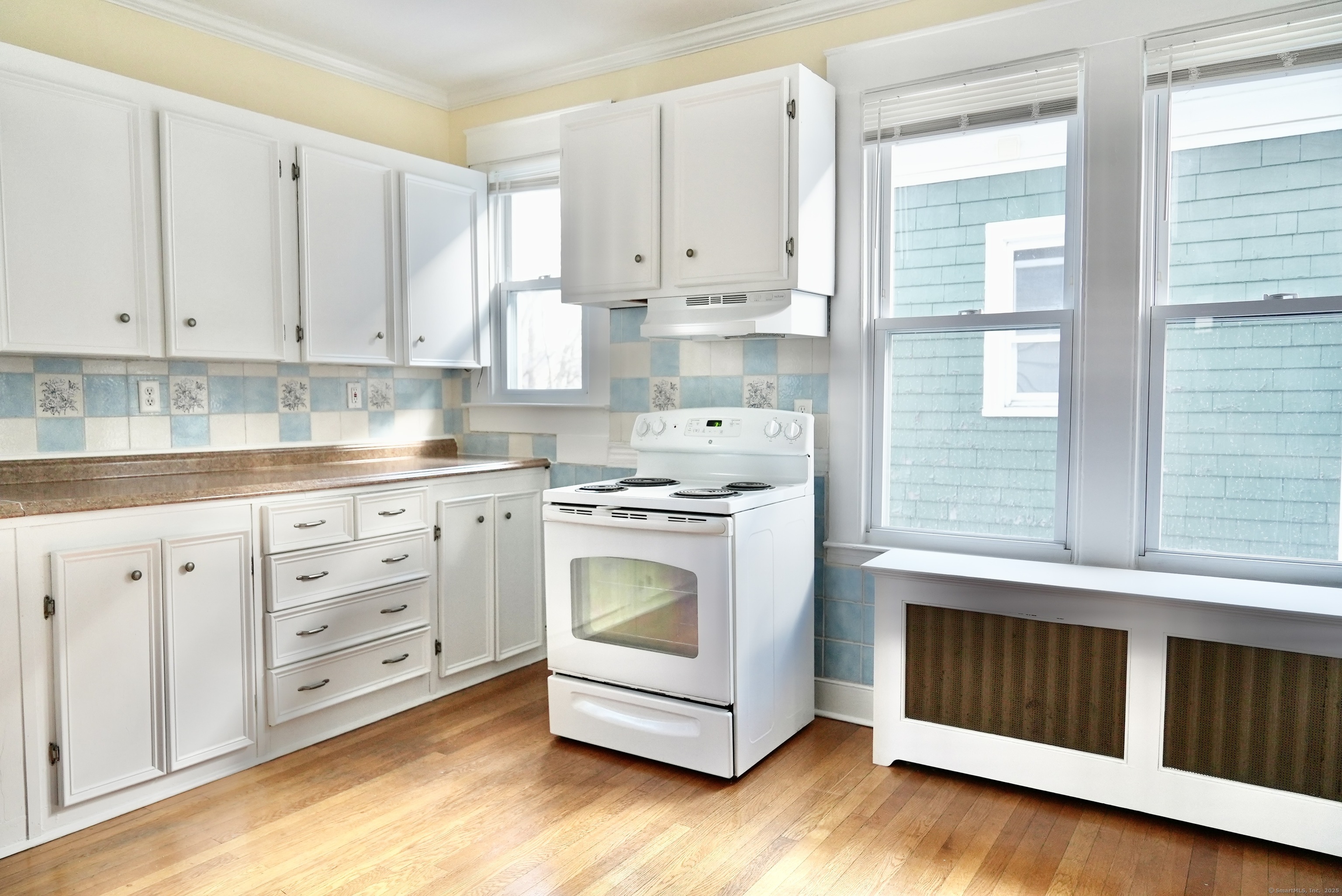 39 Pardee Place New Haven, CT 06515 - Photo 11 of 32 a kitchen with white cabinets and white appliances