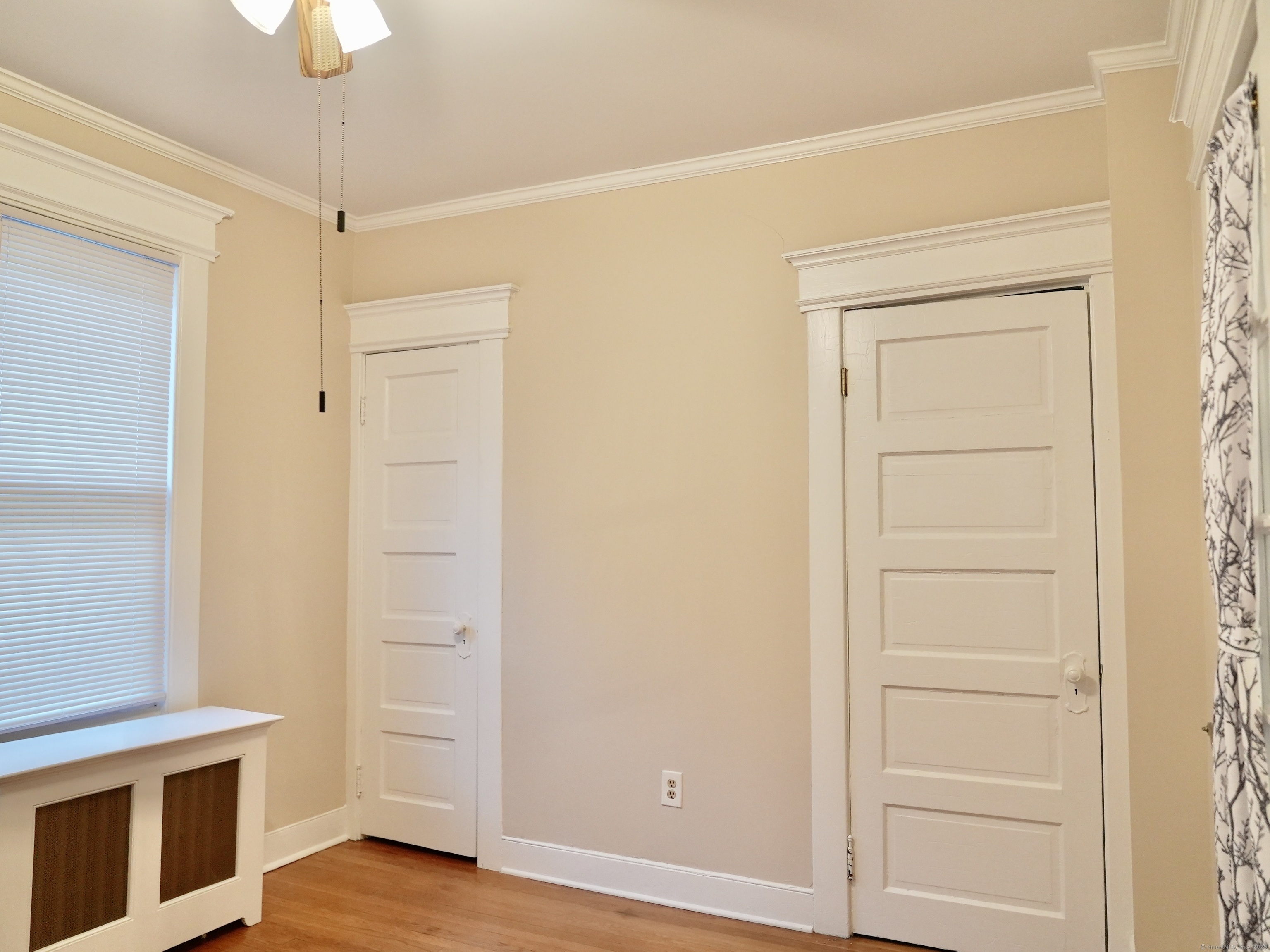 39 Pardee Place New Haven, CT 06515 - Photo 16 of 32 a view of an empty room with wooden floor and a window
