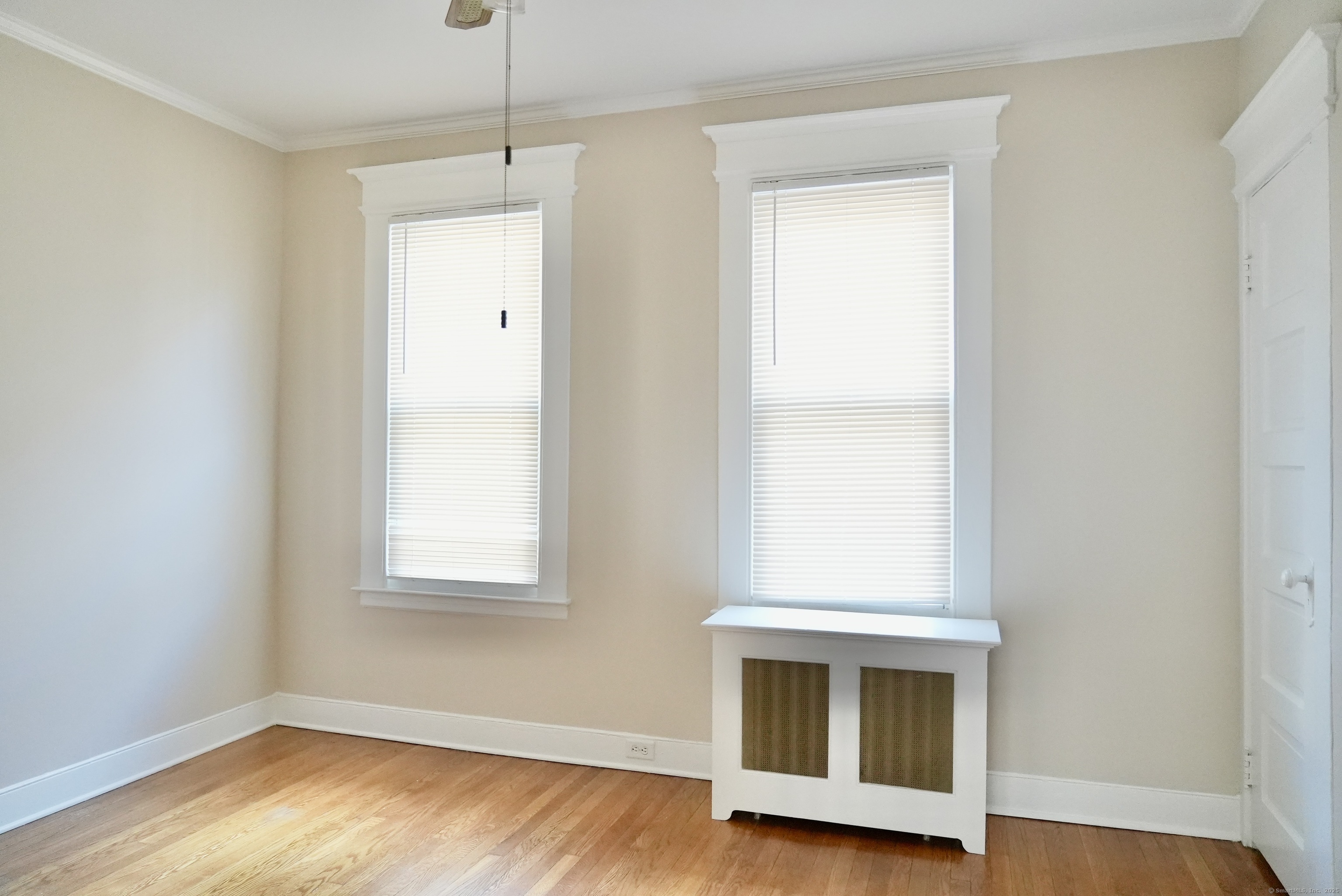 39 Pardee Place New Haven, CT 06515 - Photo 17 of 32 a view of an empty room with wooden floor and a window