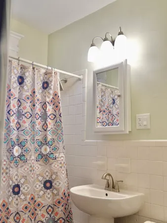 a bathroom with a sink and mirror with toilet